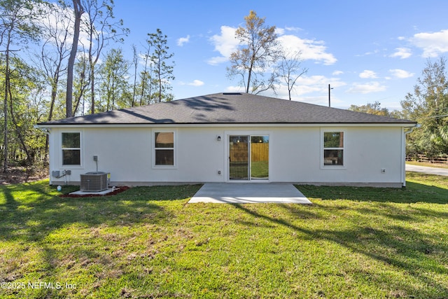 back of property featuring a patio, a lawn, central AC unit, and roof with shingles