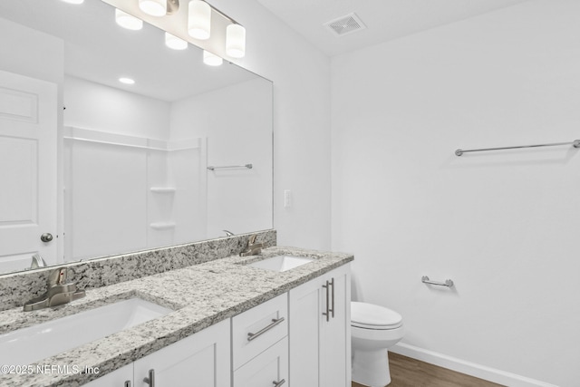 full bath featuring visible vents, toilet, baseboards, and a sink