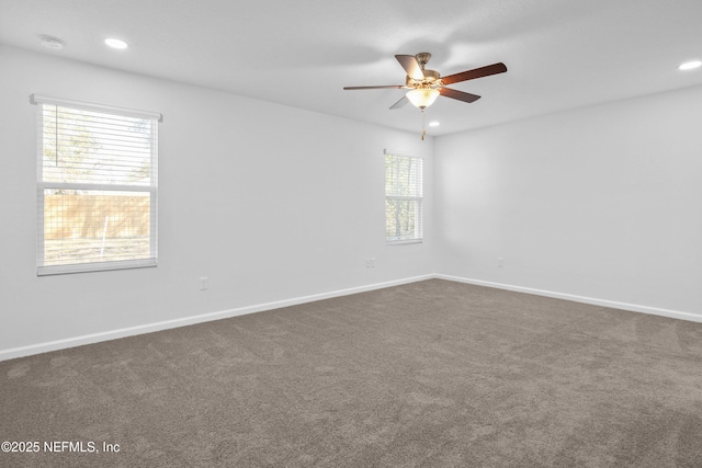 spare room with recessed lighting, baseboards, ceiling fan, and dark colored carpet