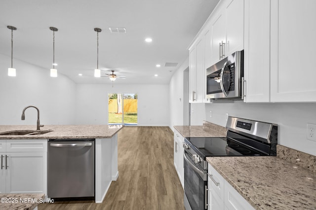 kitchen with visible vents, a sink, white cabinets, light wood-style floors, and appliances with stainless steel finishes