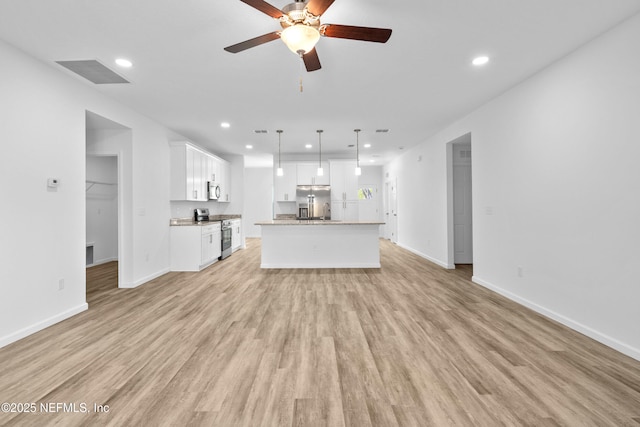 unfurnished living room with visible vents, recessed lighting, and light wood-type flooring