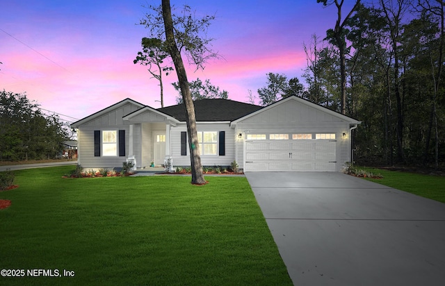 ranch-style house with concrete driveway, an attached garage, board and batten siding, and a front lawn