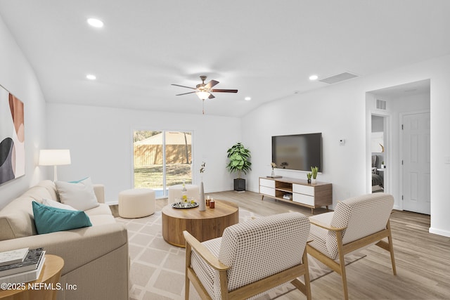 living area with wood finished floors, recessed lighting, and visible vents