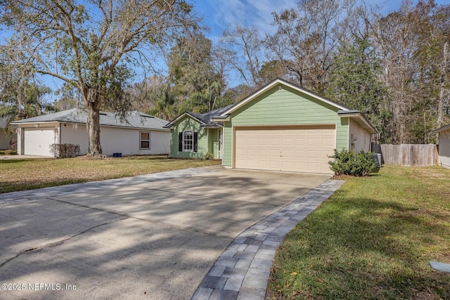 ranch-style home with driveway, a front lawn, an attached garage, and fence