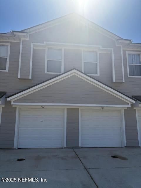 view of front facade featuring concrete driveway and an attached garage