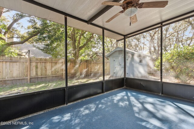 unfurnished sunroom with ceiling fan