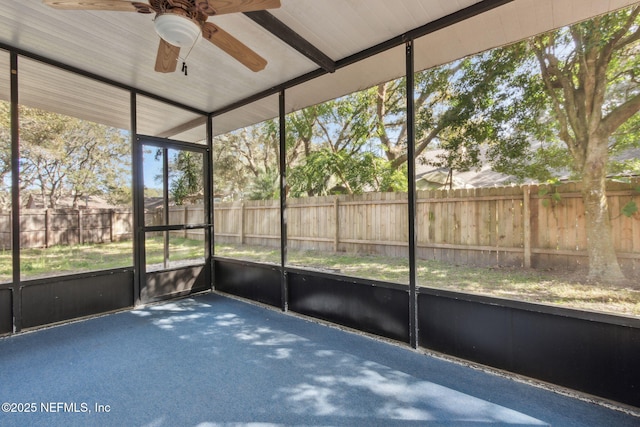 unfurnished sunroom with ceiling fan