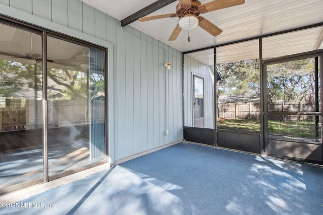 unfurnished sunroom with a ceiling fan