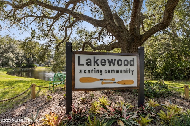 community / neighborhood sign with a water view