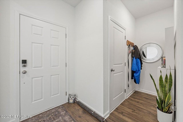 interior space with baseboards and wood finished floors