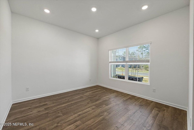 unfurnished room featuring dark wood-style floors, baseboards, and recessed lighting