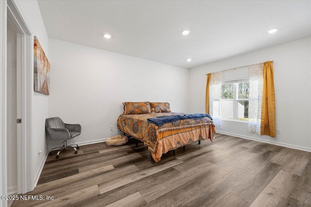 bedroom featuring recessed lighting, baseboards, and wood finished floors