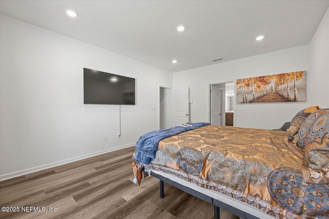 bedroom with recessed lighting, visible vents, a textured ceiling, wood finished floors, and baseboards