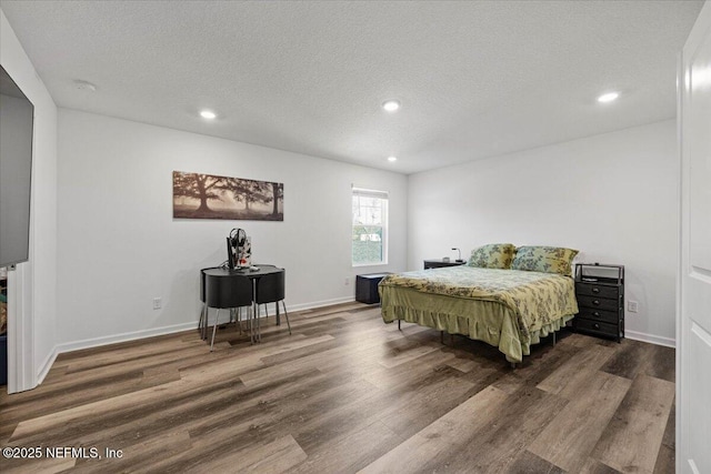 bedroom featuring recessed lighting, a textured ceiling, and wood finished floors