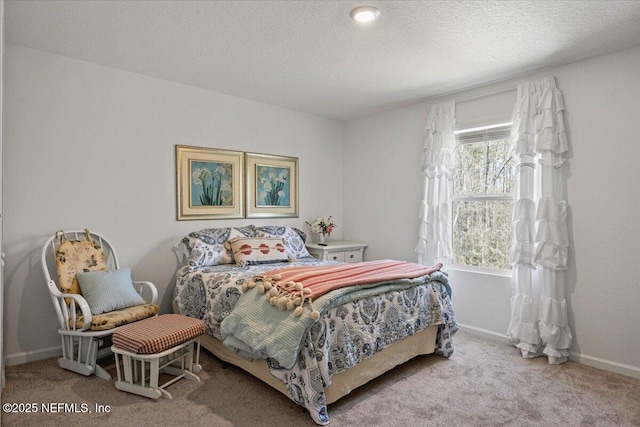 carpeted bedroom featuring baseboards and a textured ceiling