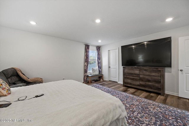 bedroom with wood finished floors and recessed lighting