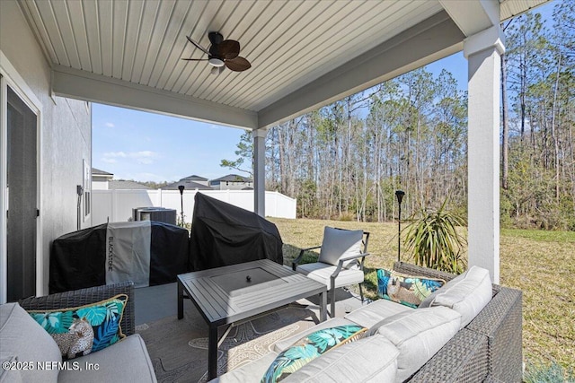 view of patio / terrace featuring a grill, fence, an outdoor living space, and a ceiling fan