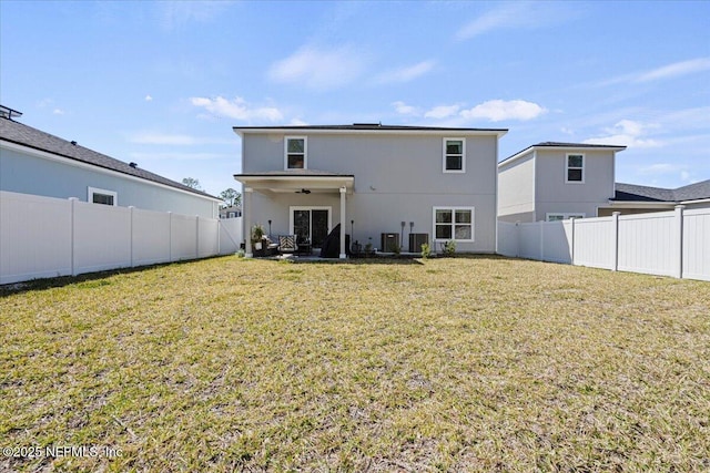 back of property featuring a fenced backyard, a yard, a patio, and central AC unit