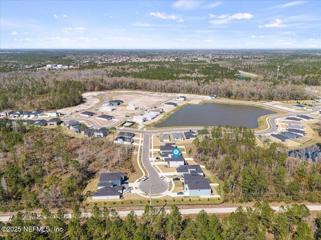 bird's eye view with a water view and a view of trees