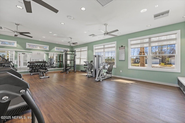 workout area featuring baseboards, visible vents, wood finished floors, and recessed lighting