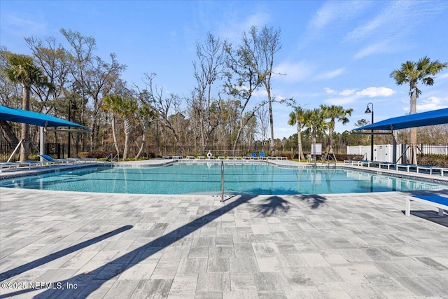 pool with fence and a patio