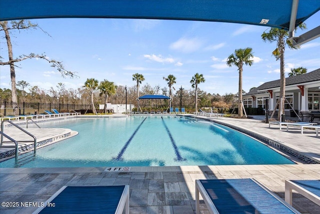 community pool featuring fence and a patio