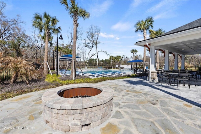 view of patio / terrace featuring a fire pit and a community pool