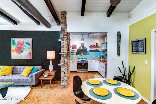 living room with beam ceiling and track lighting