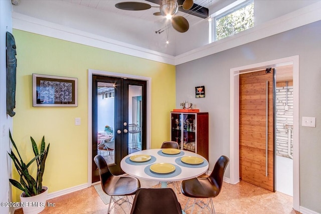 dining room featuring french doors, a ceiling fan, and baseboards