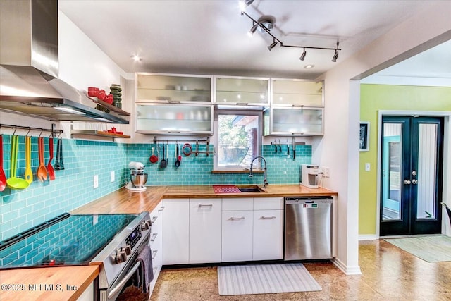 kitchen featuring a sink, wooden counters, appliances with stainless steel finishes, and island exhaust hood