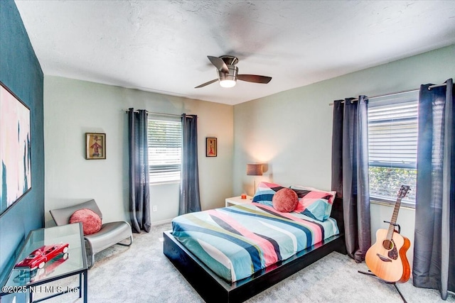 bedroom with carpet, baseboards, and a ceiling fan