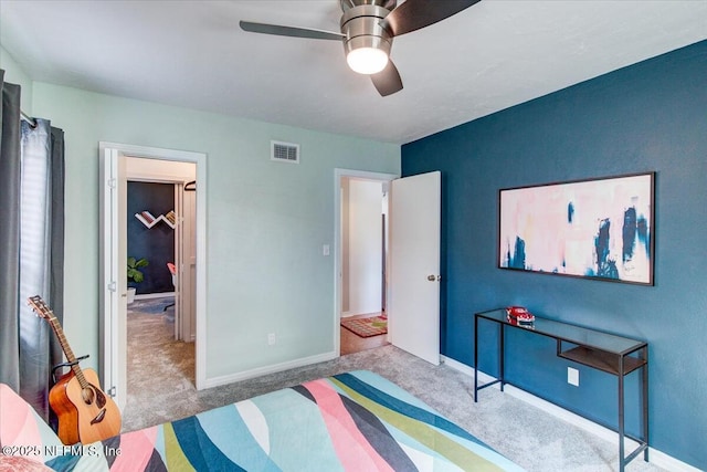 bedroom with carpet floors, visible vents, baseboards, and a ceiling fan