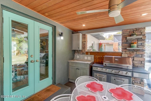 interior space featuring outdoor dining space, an outdoor kitchen, area for grilling, and french doors