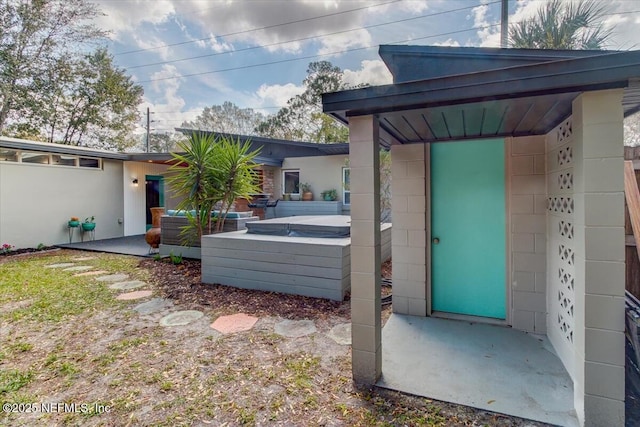 exterior space with a hot tub