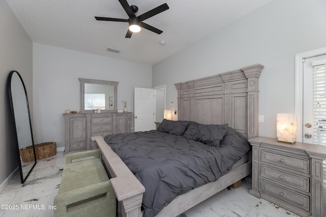 bedroom with lofted ceiling, marble finish floor, visible vents, and a textured ceiling