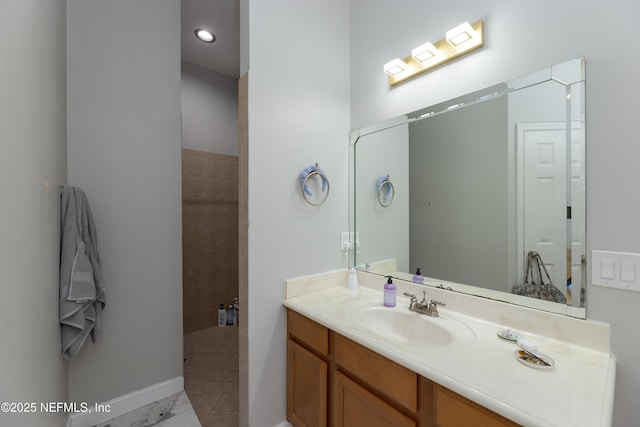 full bath featuring vanity and baseboards