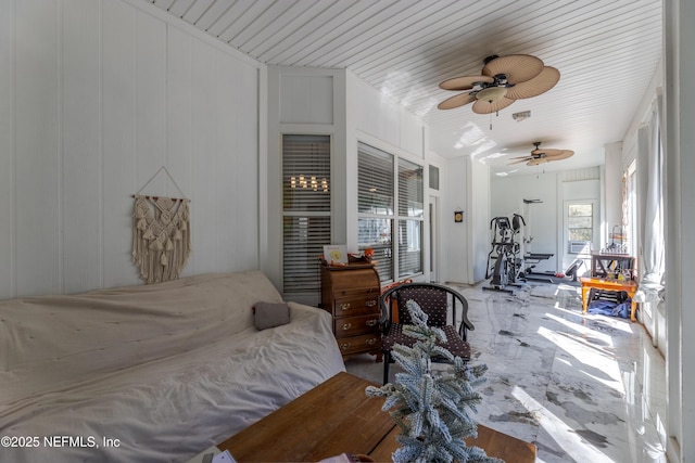 bedroom with ceiling fan and marble finish floor