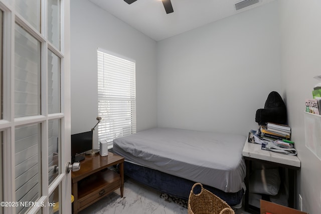 bedroom with marble finish floor, visible vents, and a ceiling fan