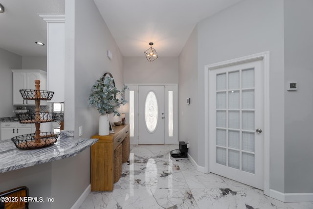 entrance foyer featuring marble finish floor, baseboards, and recessed lighting