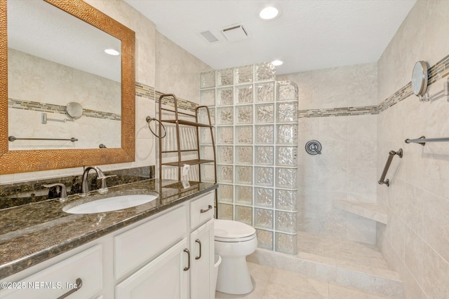 full bath with visible vents, toilet, tile patterned flooring, walk in shower, and vanity