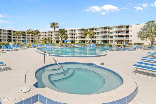 community pool with a community hot tub and a patio