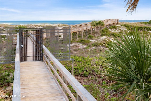 property view of water with a view of the beach and a gate