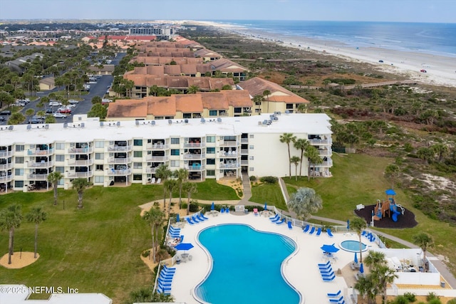 drone / aerial view featuring a beach view and a water view