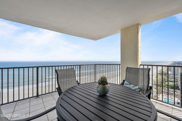 balcony featuring a water view and a view of the beach