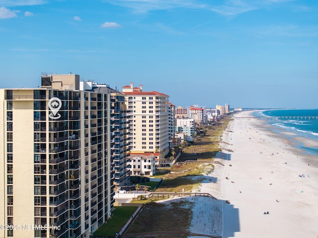 birds eye view of property with a water view, a beach view, and a city view