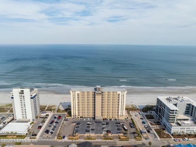 birds eye view of property featuring a water view and a view of the beach