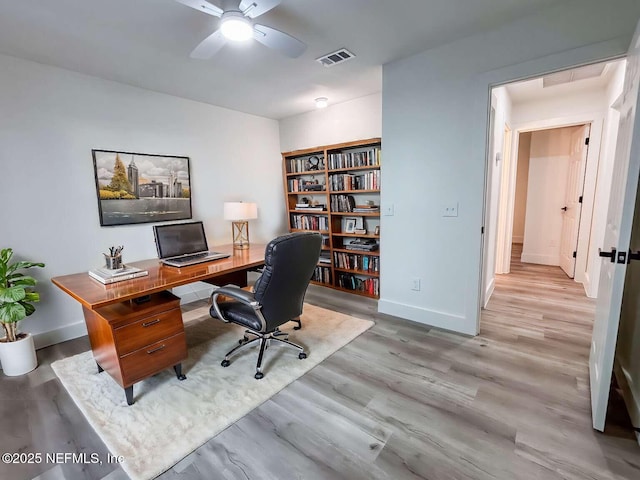 office area featuring ceiling fan, wood finished floors, visible vents, and baseboards