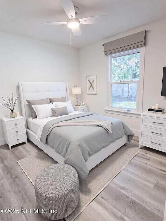 bedroom featuring baseboards, ceiling fan, and light wood finished floors