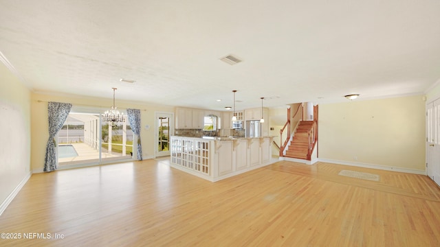 unfurnished living room featuring visible vents, baseboards, stairs, ornamental molding, and light wood-type flooring