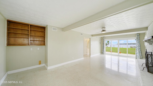 empty room featuring ceiling fan, speckled floor, visible vents, baseboards, and a brick fireplace